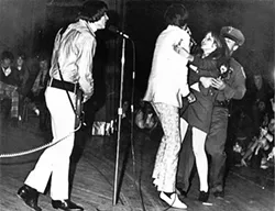 HYSTERIA!: A girl rushes the stage and grabs The Seeds frontman Sky Saxon at one of their shows. - IMAGE COURTESY OF GNP CRESCENDO RECORDS
