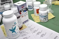 MED CENTRAL: Although most of the medication and vitamins that Waves of Health brings on each mission are donated, the nonprofit spends between $8,000 and $12,000 per trip on medicine that it can’t procure through donations. - PHOTO BY CAMILLIA LANHAM