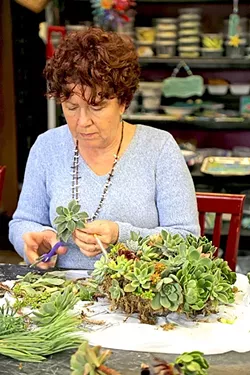MADE WITH LOVE: Diane Toman works on a handmade succulent wreath at the Design Studio in Los Osos. - PHOTO BY DYLAN HONEA-BAUMANN