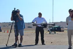 DRONE DEMO: The InstantEye drone, manufactured by Boston-area tech company Physical Sciences Inc., hovers at Camp Roberts’ McMillan airfield during a Joint Interagency Field Exploration (JIFX) event. - PHOTO BY RHYS HEYDEN