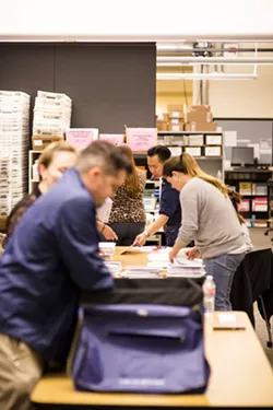 Election night in SLO County: Vote counters included Tommy Gong, candidate for SLO County Clerk-Recorder. - PHOTO BY HENRY BRUINGTON