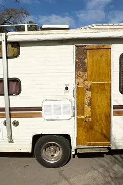 KNOCK KNOCK: At about 3 a.m. on Feb. 16, SLO police officers went from vehicle to vehicle, banging flashlights on doors and shaking RVs, to roust the sleeping occupants and issue them warnings and citations for illegally using a car as a dwelling. - PHOTO BY STEVE E. MILLER