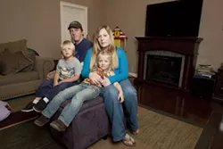 GETTING BY : Molly O’Leary and Ryan Risley are getting by now, but they don’t know how they’ll afford to stay at home with their kids if a $250-per-month sewer bill forces them both to work full time. - PHOTO BY STEVE E. MILLER
