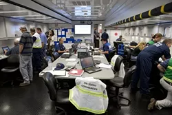 SCIENCE AT WORK : Task force members from the U.S. Coast Guard and California Department of Fish and Game begin Day 4 of their mission in the mobile command center. - PHOTO BY STEVE E. MILLER