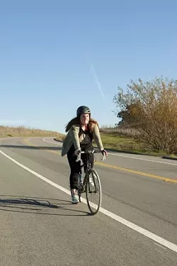 CYCLING THROUGH : Calendar editor Maeva Considine bikes away the calories with the help of the Cyclemeter app for iPhones. - PHOTO BY STEVE E. MILLER