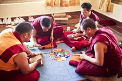 MIND PALACE: The sand mandala typically takes several days to create. The mandala is described as the “imaginary palace of the Buddha,” and is visualized during meditation. Upon its completion, the sand mandala is ceremonially destroyed, symbolizing the impermanence of all that exists. - PHOTO COURTESY OF ANET CARLIN