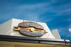 MARKET FRESH: San Luis Obispo metal wizard Jory Bringham created Lincoln Market’s eye-catcing sign as well as the large community table found inside the eclectic hangout, grocery, and deli. - PHOTO BY KAORI FUNAHASHI