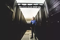 SERVER FARMER: Tim Williams, founder and CEO of Digital West, a San Luis Obispo-based data storage and web hosting company, has pioneered efforts to improve telecom infrastructure—and incorporate more fiber-optics—in SLO County. - PHOTO BY HENRY BRUINGTON