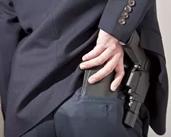 OUT OF SIGHT, ON THE MIND : More San Luis Obispo County residents have applied for concealed weapons permits in the last two years than in the previous two. - PHOTO ILLUSTRATION BY STEVE E. MILLER