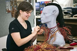 WAR NECKLACE :  Weta costume technician Claire Prebble assembles a war necklace for Tsu&rsquo;tey, a character from James Cameron&rsquo;s Avatar. While the version you see onscreen was computer generated, Weta typically makes such items through traditional methods first. Then, 3-D modeling artists copy the physical item as closely as possible. - PHOTO BY STEVE UNWIN