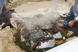 UNCOVERED : As a preview for the main event in September, the Sea Venture restaurant held a clambake for the media lunch. Here, the canvas has just come off of the food. - PHOTOS BY STEVE E. MILLER