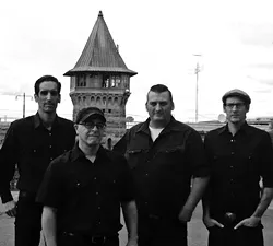 FOLSOM PRISON BLUES: Johnny Cash tribute act Cash’d Out, shown here in front of Folsom Prison, returns to SLO Brew on March 21. - PHOTO COURTESY OF CASH’D OUT