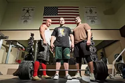 STRONGMEN : Ian Smalley (left), Alan Best, and George Beckham (right) practice heavy metal magic at Estrada’s Gym in SLO; Best stands over a 771-pound bar, his world-record deadlift. - PHOTO BY STEVE E. MILLER