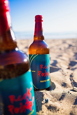 APPLE OF YOUR MOUTH:  Made in Cayucos by local boys, it made perfect sense that these frosty bottles of Reef Points Kid Neptune hard cider would be enjoyed at the inspiration&rsquo;s source. - PHOTO BY KAORI FUNAHASHI