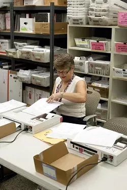 MAKING 'EM COUNT: County clerk-recorder Julie Rodewald was extra busy counting mail-in ballots and the returns from polling stations on election night. - PHOTO BY STEVE E. MILLER
