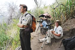 EAGLE EYE : U.S. Fish and Wildlife’s Michael Woodbridge peers across a canyon toward a condor nest with volunteers from the nest-guarding program. - PHOTO BY PAUL WELLMAN