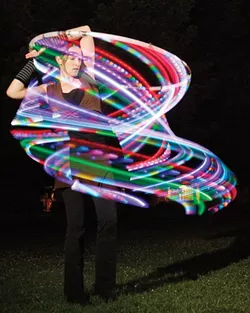 RAINBOW ROAD: Laurie Hobbs, one of the founders of Fluid Luminescence, teaches hoop-dancing workshops. - PHOTO BY STEVE E. MILLER