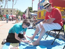 MACHO MAN : Mark Mastache isn't afraid of a little paint. His daughter Megan Mastache, who organized the event, layers it on thick before saving the day with plenty of pictures for our Art Basher and his battery deficient camera. - PHOTO COURTESY OF MEGAN MASTACHE