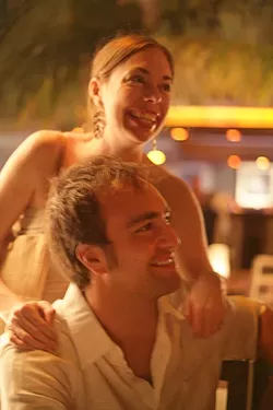 LOVE GLOW : Rubey and Gabe share a laugh with friends at their rehearsal dinner in Playa del Carmen, Mexico. - PHOTO BY GLEN STARKEY
