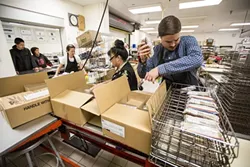 PREPARATION STATIONS: Laguna’s busy central kitchen is the point of origin for most of the food served to the more than 7,000 students in the San Luis Coastal Unified School District. - PHOTO BY HENRY BRUINGTON