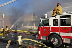 ASHES TO ASHES : SLO firefighters worked for hours to put out an aggressive fire that gutted a popular novelty store on Higuera Street Dec. 26. The cause of the blaze has not yet been determined. - PHOTO BY DYLAN HONEA-BAUMANN
