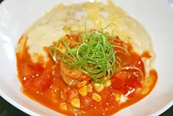 GOT GRITS? : Shrimp swim in a creamy bowl of hand-milled grits, white cheddar, roasted corn, and tomato. - PHOTO BY HAYLEY THOMAS