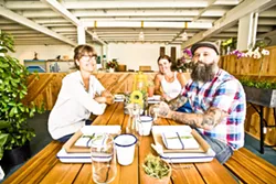HUCKLEBERRY WIN: Carla Wingett and Karen Irwin, the owners of Huckleberry Market, are teaming up with local painter Neal Breton to bring an artistic spark to their store. - PHOTO BY HENRY BRUINGTON