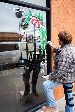 POODLE PRESENT: Seim has been painting windows and store signs on the Central Coast for 40 years. Some of her clients include the Animal Kingdom Pet Shop in Grover Beach (below). - PHOTO BY KAORI FUNAHASHI