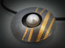 I’LL FOLLOW THE SUN: Ina Hohensee’s “wearable art” jewelry, including her Sun Pendant (pictured), weds contemporary forms with elements from nature. - PHOTO COURTESY OF STUDIOS ON THE PARK