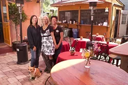 WINE, FOOD AND BOOKS: Owners (l-r Jill Knight, Lyn Nanni, and Eileen Nunes along with Willow (the dog) have recently opened a spacious indoor and outdoor wine bar that serves food and has a variety of books for sale. - PHOTO BY STEVE E. MILLER