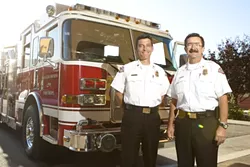 PASSING THE AXE: San Luis Obispo’s current deputy fire chief Garret Olson (left), will take over for the outgoing Charlie Hines on Sept. 12. - PHOTO BY STEVE E. MILLER