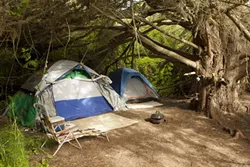 CAMPING DOS AND DON’TS : While some Morro Creek campsites are obviously trashed, others are well maintained. All will be removed. - PHOTOS BY STEVE E. MILLER