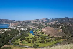 THE AVILA TRIAD: As seen from Ontario Ridge, Avila Point (far left), the Avila Beach Golf Resort (center), and Wild Cherry Canyon (background) surround the tiny community of Avila Beach. The ultimate fate of development plans at all three sites could significantly impact the future of Avila. - PHOTO BY KAORI FUNAHASHI