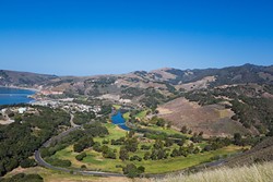 THE AVILA TRIAD:  As seen from Ontario Ridge, Avila Point (far left), the Avila Beach Golf Resort (center), and Wild Cherry Canyon (background) surround the tiny community of Avila Beach. The ultimate fate of development plans at all three sites could significantly impact the future of Avila. - PHOTO BY KAORI FUNAHASHI