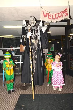 WORLD’S TALLEST GREETER!: In addition to the haunted house, kids can get photos with scary characters and win prizes from carnival games. - PHOTO BY BETTY "DOC" O'CONNOR