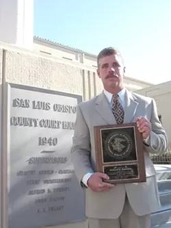 PATIENT: Medical marijuana patient Richard Steenken was arrested for growing marijuana in his home and held for 21 days, before charges were dropped and he was released. Trained as a drug and alcohol counselor, Steenken received the plaque he’s holding from the - PHOTO BY KYLIE MENDONCA