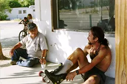 WHAT THE…? : Englishman Jason Lewis, right, gets a second glance from a local as he skates his way through California’s Central Valley. On his way to becoming the first person to complete a human-powered circumnavigation of the earth, Lewis also became the first to inline skate across the North American continent. - PHOTO BY KENNY BROWN