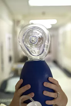 BREATHE: During an overdose, heroin will block receptors in the brain responsible for causing a person’s body to keep breathing when they are unconscious. A hand-held respirator is used to force a patient to breathe long enough for Narcan to be administered. - PHOTO BY STEVE E. MILLER