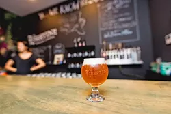 SWEET N SOUR: Libertine Pub’s new 9,000-square-foot brewing facility is home to a cozy-yet-edgy tasting room at 1234 Broad St. in Downtown SLO. Founder and head of brewing operations Tyler Clark aims to transform the space into a place for wild sour beers as well as cold brew coffee, food, and local artisanal goods. - PHOTO BY KAORI FUNAHASHI