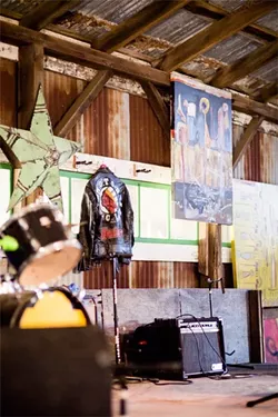 RARE STYLE: This leather jacket was given to SLO Tracks founder and local musician Vincent Bernardy during his days as a Minneapolis area booker in the late ’80s and early ’90s. Only a handful were made, two of which went to Madonna and one to Prince. The rock-n-roll relic now hangs alongside local artwork at the Edna Valley barn-turned-venue, which aims to provide a thoughtfully-curated lineup of all-ages shows in 2014. - PHOTO BY HENRY BRUINGTON