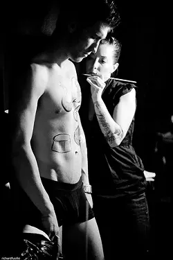 BODY AS CANVAS : An artist paints a model before sending him down the runway, at last year’s Embodiment. - PHOTO BY RICHARD FUSILLO