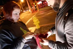KNIT TAGGERS : Neal Breton and Adriana Hernandez tag downtown SLO with colorful knitted squares on June 24. - PHOTO BY STEVE E. MILLER