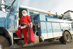 BYE BYE SLEIGH: Santa escapes the stress of working at the North Pole with a part-time job with PG&E. - PHOTO BY STEVE E. MILLER