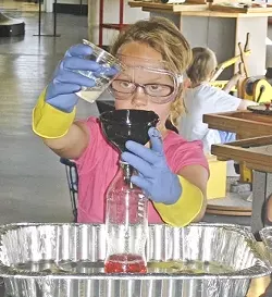 SHE BLINDED ME WITH SCIENCE: Ajhri Kehler gets her learning on at the Exploration Station in Grover Beach. - PHOTOS BY TOSHA PUNCHES