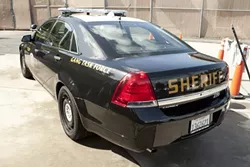 GANG BUSTERS : As the Sheriff’s Department amps up its anti-gang enforcement, one of its strategies is to increase its community presence, namely from behind the wheel of its new marked Chevy Caprice. - PHOTO BY STEVE E. MILLER