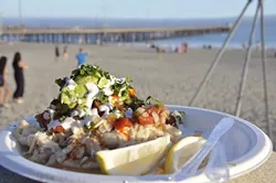 HANGER CURE: A fish taco piled high with all kinds of good stuff is synonymous with the Avila Beach Farmers’ Market. - PHOTO BY CAMILLIA LANHAM