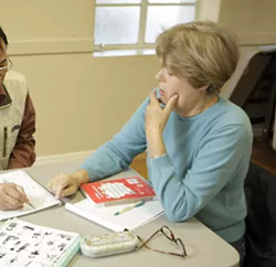 ONE LESSON AT A TIME : Mary Kleeman works with a Chinese student whose lessons are frequently interrupted by his return trips to China. - PHOTO BY STEVE E. MILLER