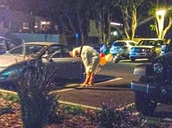 WINNER WINNER CHICKEN DINNER: Out of the shadows of Heritage Oaks Bank, a man emerged in a chicken costume carrying some balloons. Just your average Friday night. - PHOTO BY JESSICA PEÑA