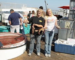 PERSONALITY :  Carol (left) and Ashley Johnson, mother and daughter, always genuinely smile, say customers of their family business, BJ&rsquo;s Live Seafood, an area favorite on the pier at Port San Luis. - PHOTO BY STEVE E. MILLER