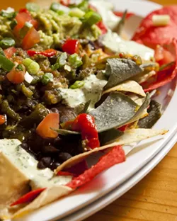 CHIP ON YOUR PLATE : The vegetarian nachos—like all this establishment’s nacho plates—are made with the chips fried to order. - PHOTO BY STEVE E. MILLER